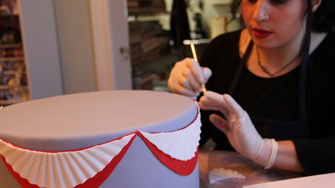 Elena Fox from Charm City Cakes works on a layer of the official cake for the Commander-in-Chief's Inaugural Ball.