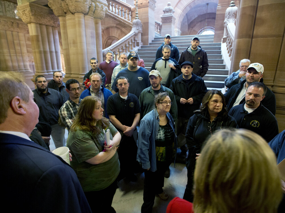 Workers from Remington Arms Company in Ilion, N.Y., talk with Assemblyman Marc Butler (left) and Assemblywoman Claudia Tenney (right) about gun legislation at the Capitol on Jan. 14 in Albany.