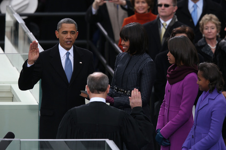 President Obama is sworn in by Chief Justice John Roberts as first lady Michelle Obama and their daughters, Sasha and Malia, look on.