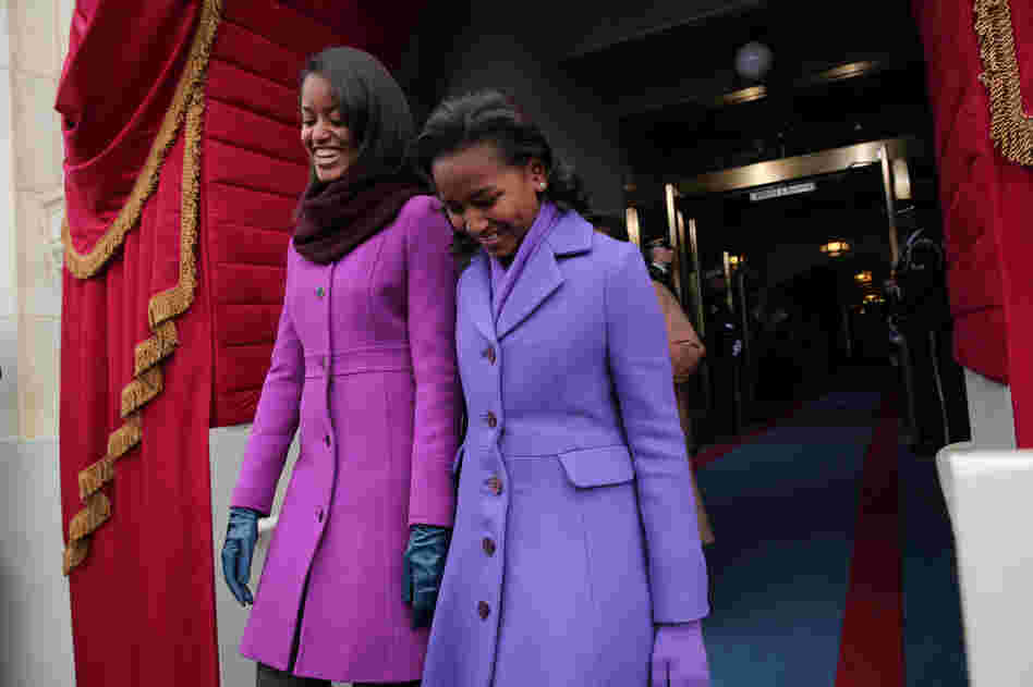 Malia Obama (left) is wearing a J.Crew coat; her sister, Sasha, wears a coat from American designer Kate Spade.