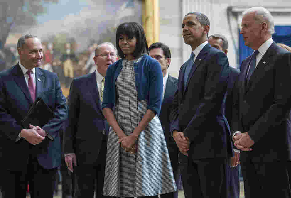 Vice President Biden, President Obama and Mrs. Obama pause to pay their respects at the Martin Luther King Jr. statue in the Capitol rotunda as they leave the inaugural luncheon. The first lady wore a cardigan she wore just the day before.