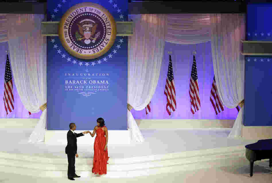 President Obama greets first lady Michelle Obama on stage during the Commander-In-Chief inaugural ball. Michelle's dress was designed by Jason Wu.
