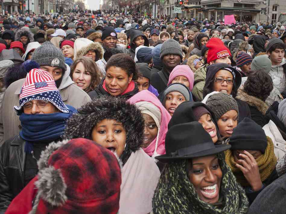 A crowd walks through downtown Washington, D.C., toward the National Mall.