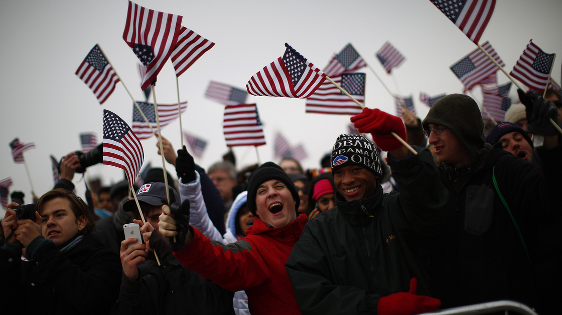 Spectators react on the National Mall during inauguration ceremonies for President Obama.