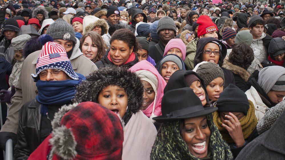 A crowds walks through downtown Washington, D.C. towards the National Mall.