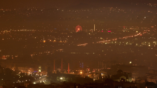 A haze of smoke hangs over Athens early Jan. 3. The hazy conditions result from residents' switch to wooden stoves and fireplaces for heating, as many households can no longer afford to buy heating oil.