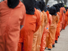 Demonstrators, dressed as detainees, march on Jan. 11 against the U.S. military detention facility in Guantanamo Bay, Cuba, and call for President Obama to close the facility. Demonstrators, dressed as detainees, march on Jan. 11 against the U.S. military detention facility in Guantanamo Bay, Cuba, and call for President Obama to close the facility.