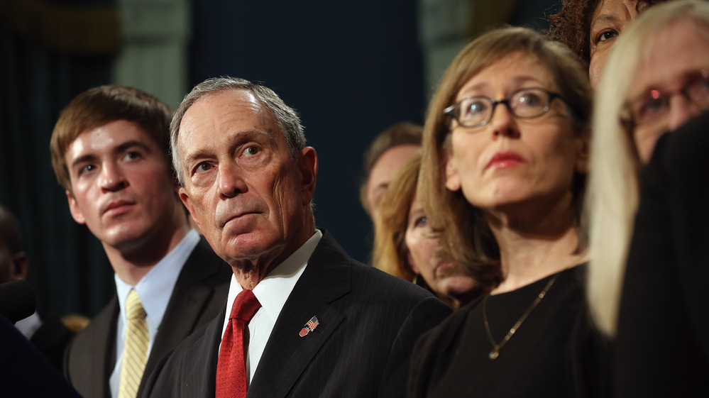 New York City Mayor Michael Bloomberg stands with people who have been affected by gun violence at a news conference at City Hall on Dec. 17, 2012.