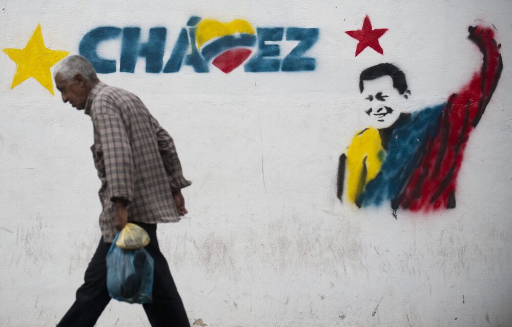 A man walks past a mural of Venezuelan President Hugo Chavez in Caracas, on Jan. 11.