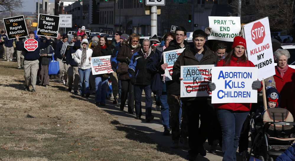 Abortion opponents march to a rally at the Kansas Statehouse in Topeka, Kan., on the 40th anniversary of Roe v. Wade. Kansas is among several states that have enacted new restrictions on abortion in recent years.