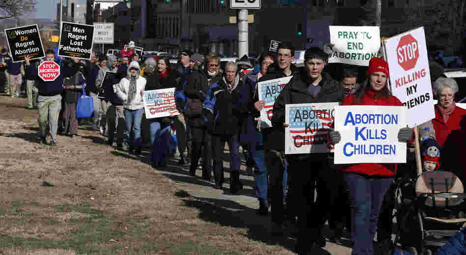 Abortion opponents march to a rally at the Kansas Statehouse in Topeka, Kan., on the 40th anniversary of Roe v. Wade. Kansas is among several states that have enacted new restrictions on abortion in recent years.