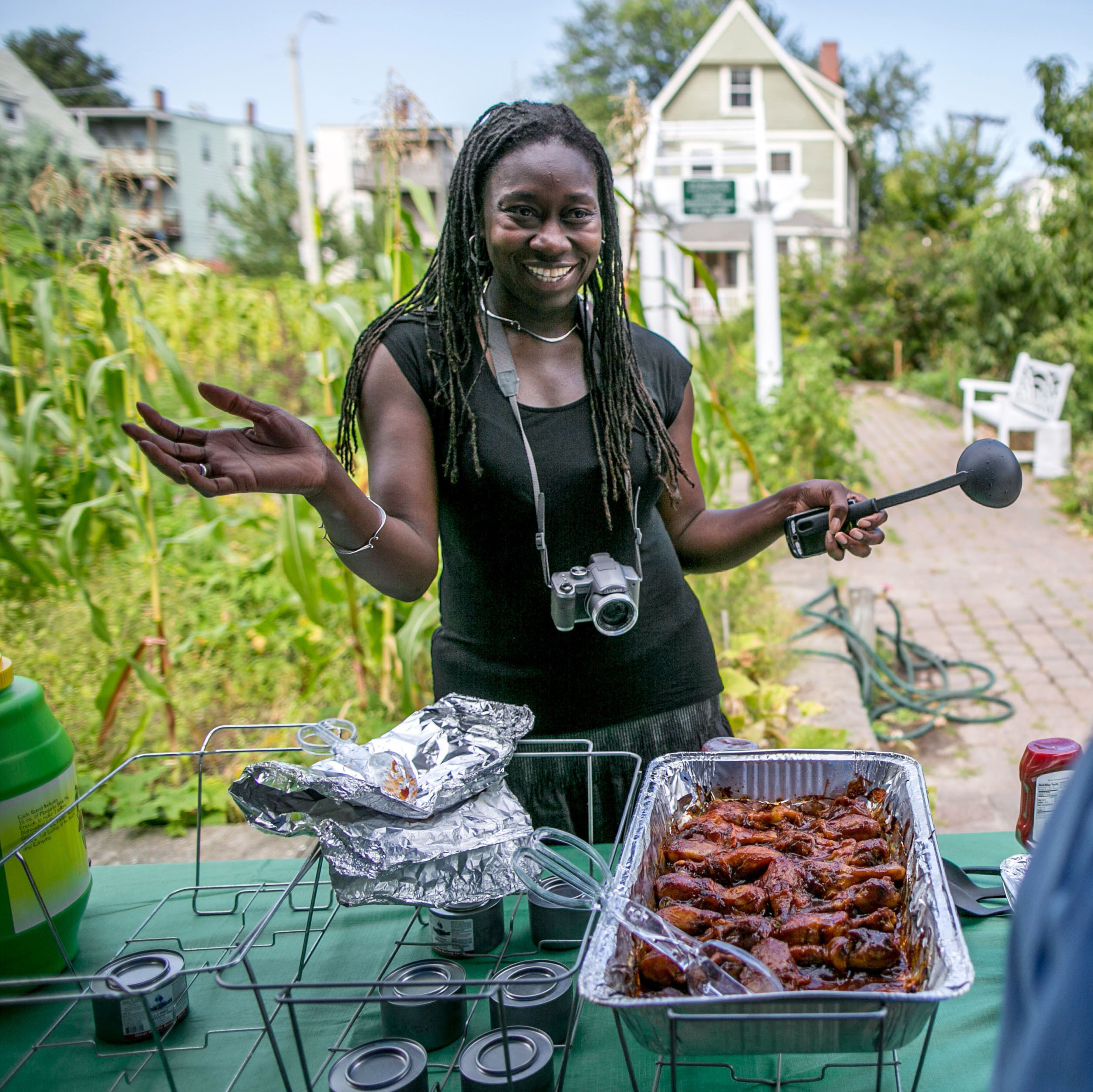 Jhana Senxian, head of the Coleman Street Association, serves food during a block party.