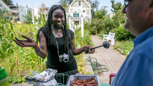 Jhana Senxian, head of the Coleman Street Association, serves food during a block party.