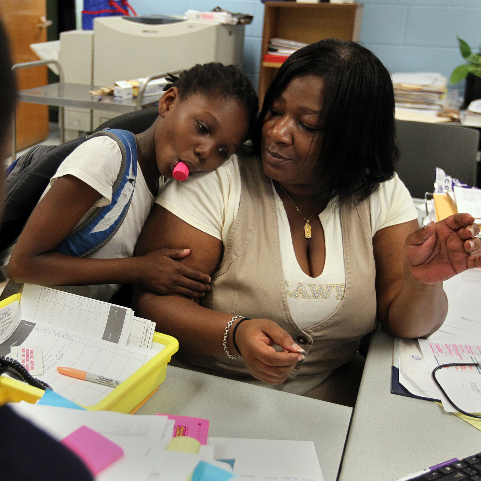 Theresa Johnson gets a hug from first grader Shaundene Funches on the last day of the year at the Marshall Elementary School in Dorchester, Mass.