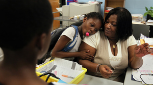 Theresa Johnson gets a hug from first grader Shaundene Funches on the last day of the year at the Marshall Elementary School in Dorchester, Mass.