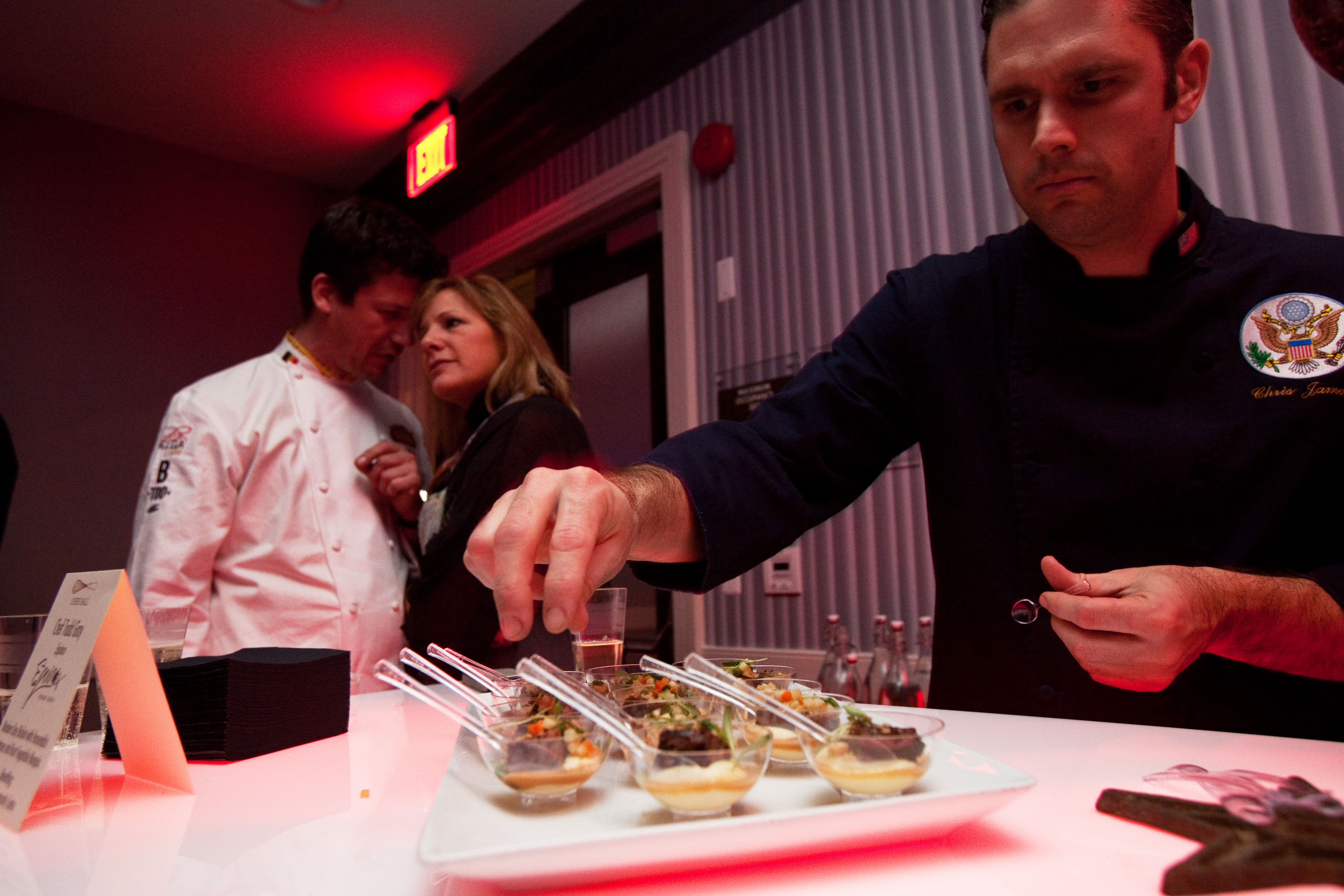 Christopher James, the State Department's deputy chef, helps plate the offerings at the Chefs Ball on Saturday, Jan. 19. The Chefs Ball was hosted by Art Smith, who decried the offerings of most balls, saying,