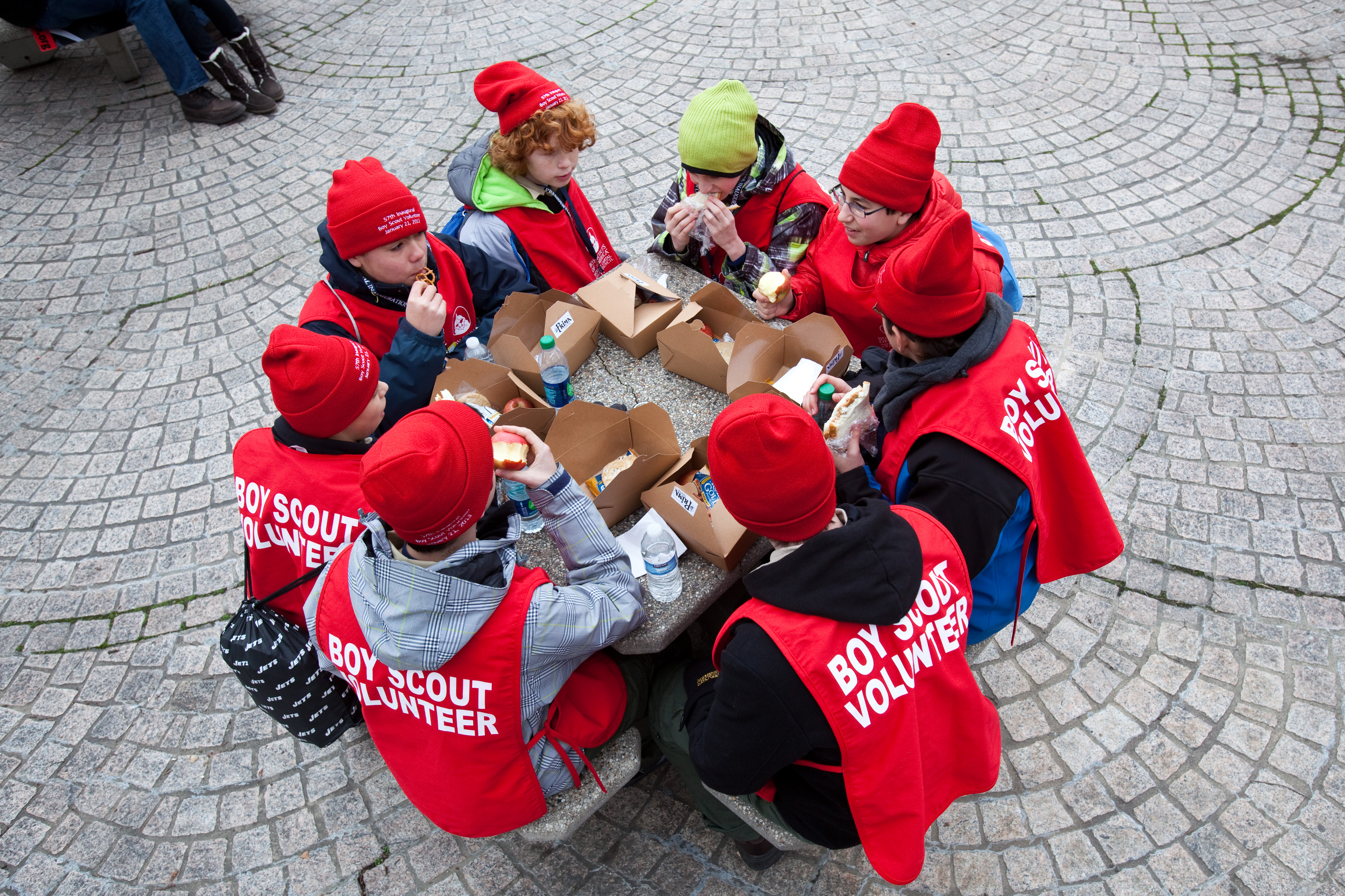 Members of New Jersey Boy Scout Troop 201, in town to help volunteer at the Inauguration Parade, take a boxed lunch break shortly before the president was sworn in for a second term.