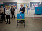 Israeli Prime Minister Benjamin Netanyahu, accompanied by his wife and sons, casts his ballot in Jerusalem on Tuesday as part of parliamentary elections. Netanyahu is expected to remain in power. Israeli Prime Minister Benjamin Netanyahu, accompanied by his wife and sons, casts his ballot in Jerusalem on Tuesday as part of parliamentary elections. Netanyahu is expected to remain in power.