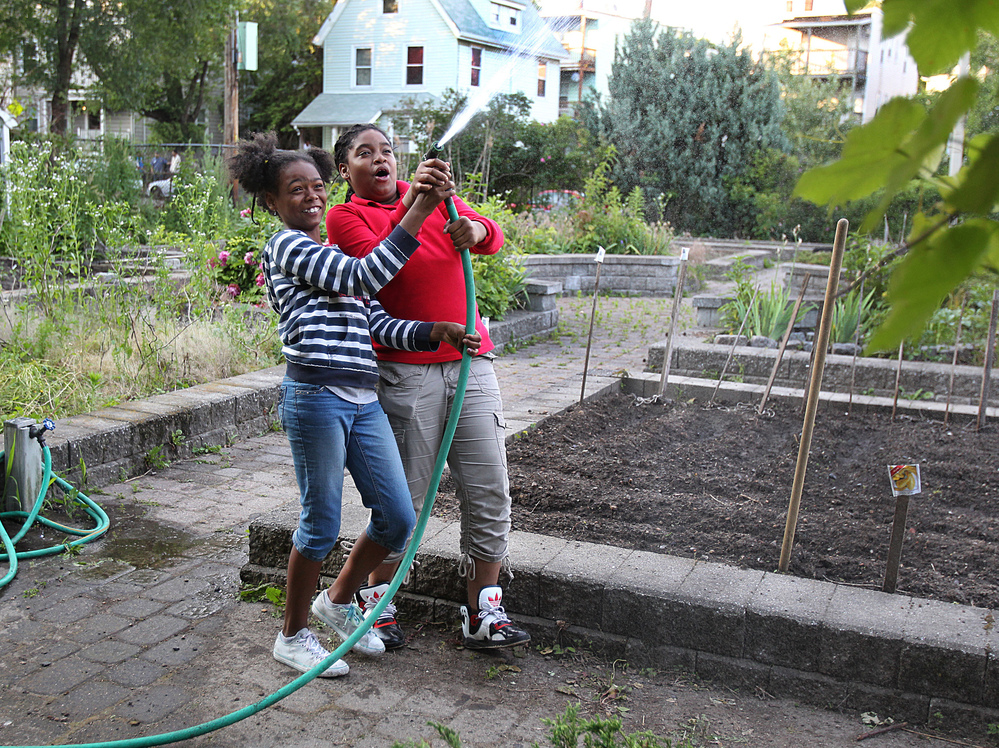 Best friends Kaori Tate and Ghiyahna Ennis explore their plot in the community garden.