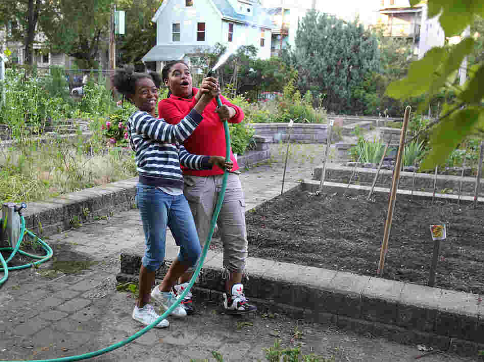 Best friends Kaori Tate and Ghiyahna Ennis explore their plot in the community garden.