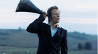 Tom Waits with a megaphone to his ear. Tom Waits with a megaphone to his ear.