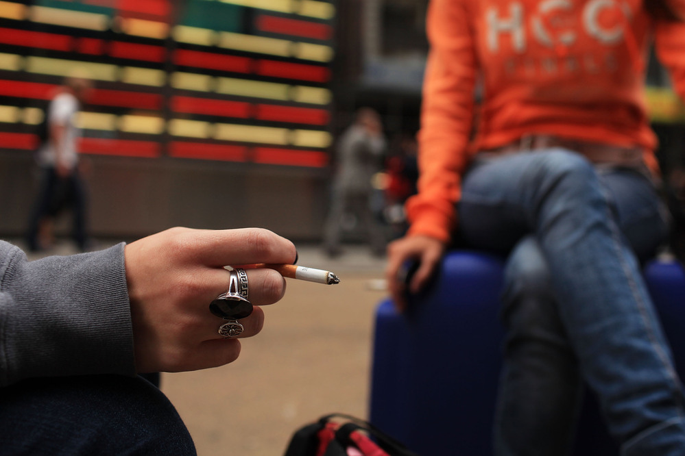 Women smoke in New York City's Times Square.