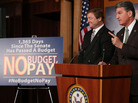 Sen. Dean Heller (left), R-Nev., and Sen. Joe Manchin, D-W.Va., speak Wednesday at the U.S. Capitol about legislation to delay a potential clash over the debt ceiling until May — and to freeze the paychecks of lawmakers if they don't pass a budget resolution. Sen. Dean Heller (left), R-Nev., and Sen. Joe Manchin, D-W.Va., speak Wednesday at the U.S. Capitol about legislation to delay a potential clash over the debt ceiling until May — and to freeze the paychecks of lawmakers if they don't pass a budget resolution.