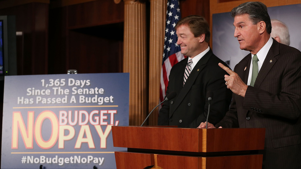 Sen. Dean Heller, R-Nev., left, and Sen. Joe Manchin, D-W.Va., speak Wednesday at the U.S. Capitol about legislation to extend a potential clash over extending the debt ceiling until May — and to freeze the paychecks of lawmakers if they don't pass a budget resolution.