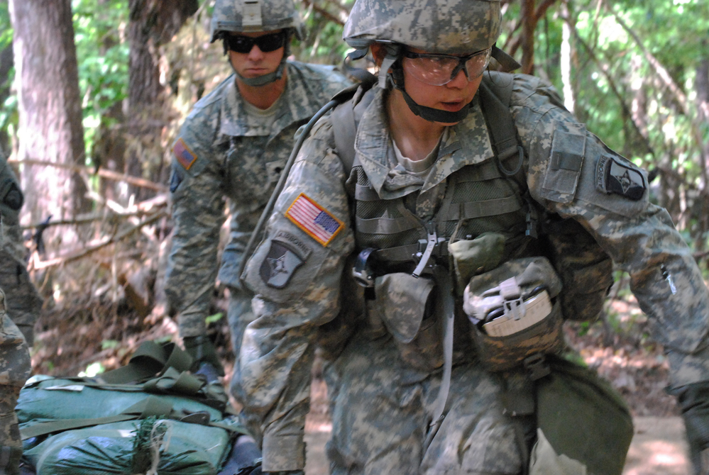 In a May 9, 2012 photo, Capt. Sara Rodriguez, 26, of the 101st Airborne Division, carries a litter of sandbags during the Expert Field Medical Badge training at Fort Campbell, Ky. Female soldiers are moving into new jobs in once all-male units as the U.S. Army breaks down formal barriers in recognition of what's already happened in wars in Iraq and Afghanistan.