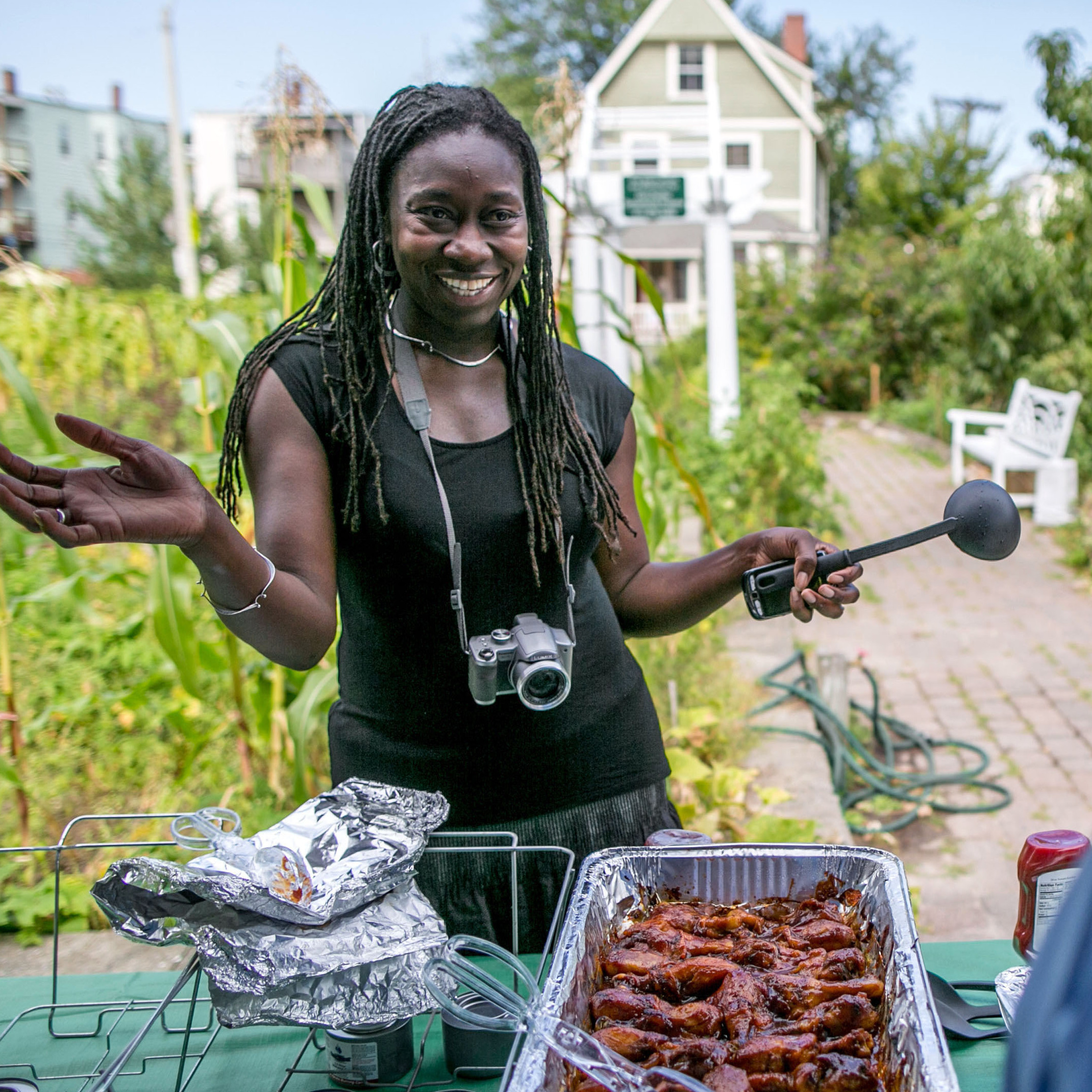 Jhana Senxian, head of the Coleman Street Association, serves food during a block party.
