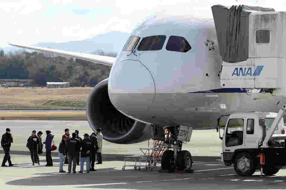 National Transportation Safety Board investigators inspect a Boeing 787 Dreamliner at Japan's Takamatsu Airport. A Federal Aviation Administration investigation into the plane's troubles has widened into a review of the agency's certification process for new airliners.