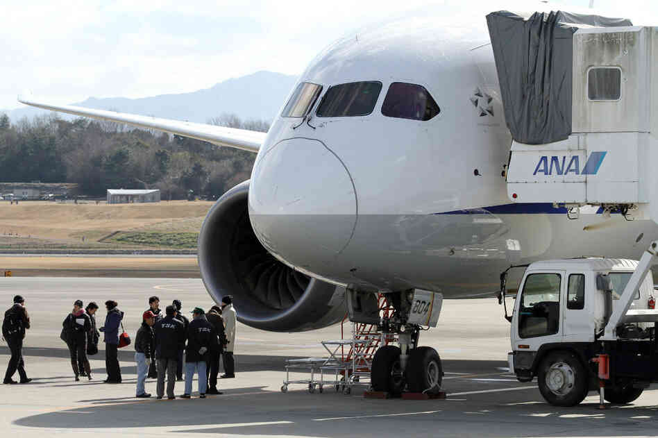 National Transportation Safety Board investigators inspect a Boeing 787 Dreamliner at Japan's Takamatsu Airport. A Federal Aviation Administration investigation into the plane's troubles has widened into a review of the agency's certification process for new airliners.
