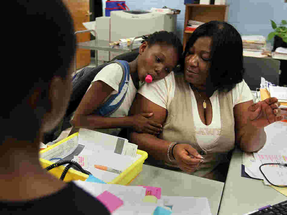 Theresa Johnson gets a hug from first-grader Shaundene Funches on the last day of the year at Marshall Elementary School in Dorchester, Mass.