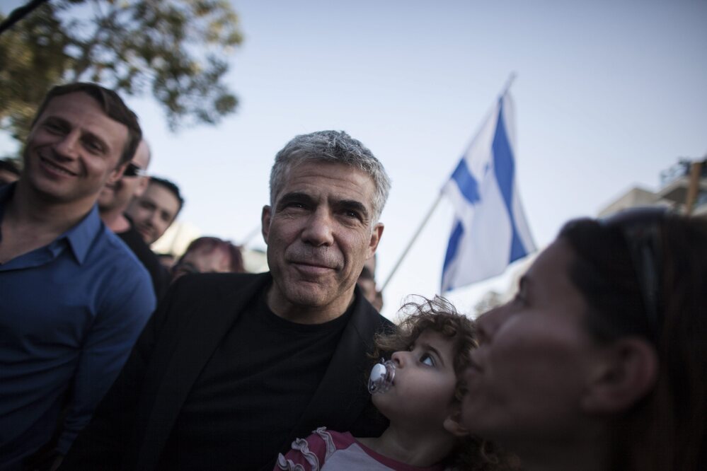 Yair Lapid and his new political party, There Is A Future, got the second-most votes in Israel's election on Tuesday. He's shown here at a polling station in Netanya, Israel.