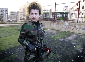 A Syrian National Defense force woman who just finished training, holds a rifle at the training center in Wadi al-Dahab in the Syrian city of Homs, on Jan. 21.