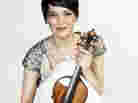 Anne Akiko Meyers, holding the "Vieuxtemps" Guarneri del Gesu violin, which reportedly sold for a record price. She says the anonymous buyer has offered her use of the instrument for life.