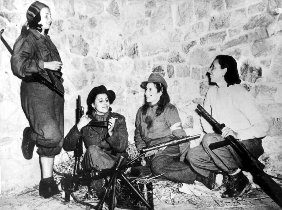 Female Italian partisans in Castelluccio, Italy, keep weapons ready as they wait for their turn to patrol with the U.S. 5th Army on Feb. 11, 1944.