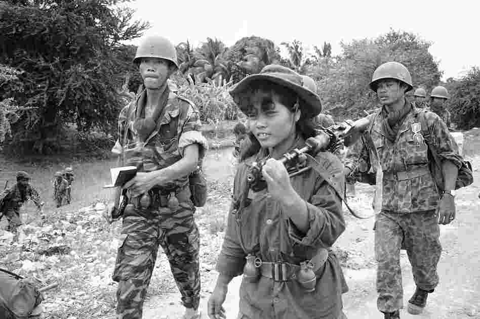 A female Cambodian soldier totes a machine gun into combat during an operation across the Mekong River from Phnom Penh in the Prek Tamak area of Cambodia on Aug. 26, 1970. This region was the scene of heavy fighting between Cambodian troops and Viet Cong. The young woman is one of many who served as regular soldiers and medics in the rapidly expanded army .