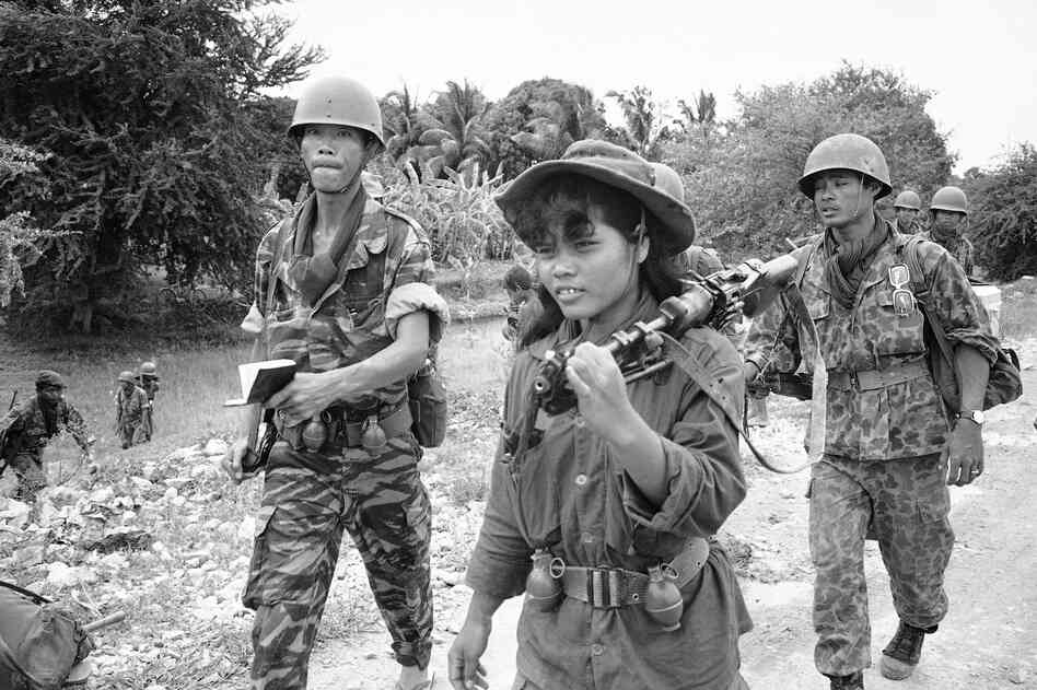 A female Cambodian soldier totes a machine gun into combat during an operation across the Mekong River from Phnom Penh in the Prek Tamak area of Cambodia on Aug. 26, 1970. This region was the scene of heavy fighting between Cambodian troops and Viet Cong. The young woman is one of many who served as regular soldiers and medics in the rapidly expanded army .