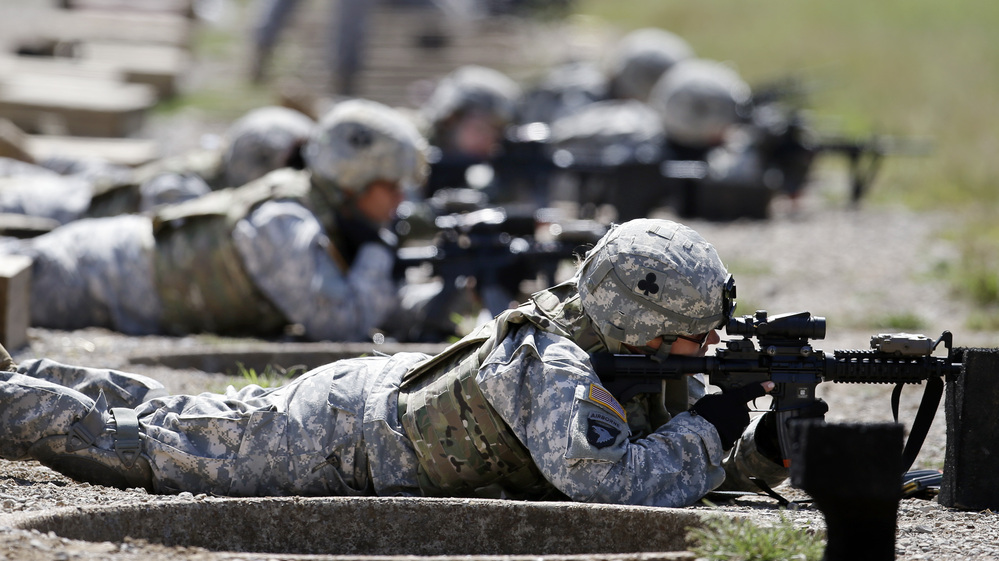 Female soldiers from 1st Brigade Combat Team, 101st Airborne Division train on a firing range in Fort Campbell, Ky., in preparation for their deployment to Afghanistan. The Pentagon announced Thursday that women will no longer be banned from combat roles.