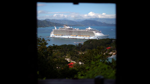 The Allure of the Seas is the newest ship in the Royal Caribbean fleet and the largest cruise ship ever built. It sits at a pier at Labadee on the coast of northern Haiti. Guests go ashore to an enclosed private beach.