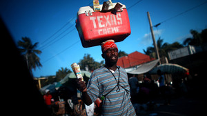 Street vendors peddle cool drinks to drivers stuck in one of the daily traffic jams on Highway 1, which is the main route out of Port-au-Prince, the Haitian capital, to the north. Traffic is one of the obstacles to tourism development in the impoverished Caribbean nation.