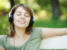 Relaxed young woman listening woman in park Relaxed young woman listening woman in park