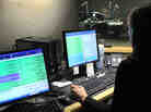 NPR Editorial Assistant Laura Lee takes and screens calls during a live broadcast of Talk of the Nation. Look just above Lee's head to see Neal Conan in the hosting chair on the other side of the glass. NPR Editorial Assistant Laura Lee takes and screens calls during a live broadcast of Talk of the Nation. Look just above Lee's head to see Neal Conan in the hosting chair on the other side of the glass.
