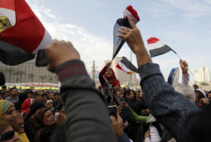 Egyptian demonstrators wave the national flag and shout slogans during a protest in Tahrir Square on January 25, 2013 in Cairo.