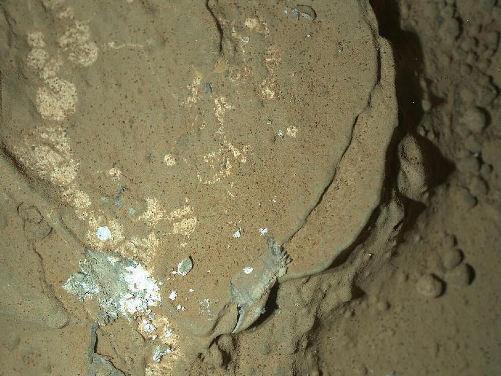 This rock target in the "Yellowknife Bay" area of Mars' Gale Crater is called "Sayunei." The image covers an area about 1.3 inches by 1 inch (3.4 by 2.5 centimeters). The illumination came from one of MAHLI's two groups of white LED pairs. This allowed surface features to cast shadows and provide textural detail.