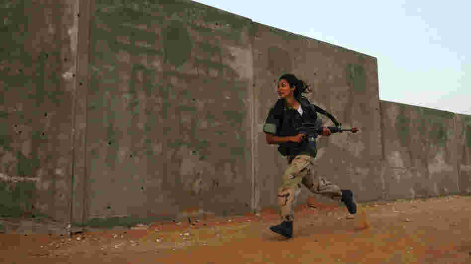 A female Israeli soldier runs during an urban warfare exercise at an army training facility near Zeelim, Israel, on June 19, 2008.