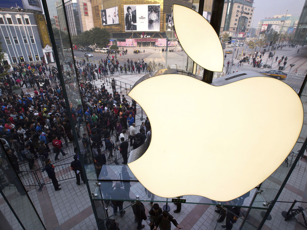 In this Oct. 20, 2012 photo, people line up to enter a newly opened Apple Store in Beijing. Exxon has once again surpassed Apple as the world's most valuable company after the iPhone and iPad maker saw its stock price falter. In this Oct. 20, 2012 photo, people line up to enter a newly opened Apple Store in Beijing. Exxon has once again surpassed Apple as the world's most valuable company after the iPhone and iPad maker saw its stock price falter.