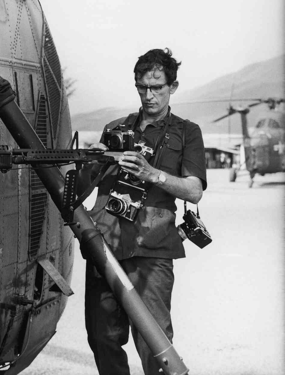 Life photographer Larry Burrows (1926-1971) attaches cameras to helicopter Yankee Papa 13 prior to a mission during the Vietnam War in 1965.