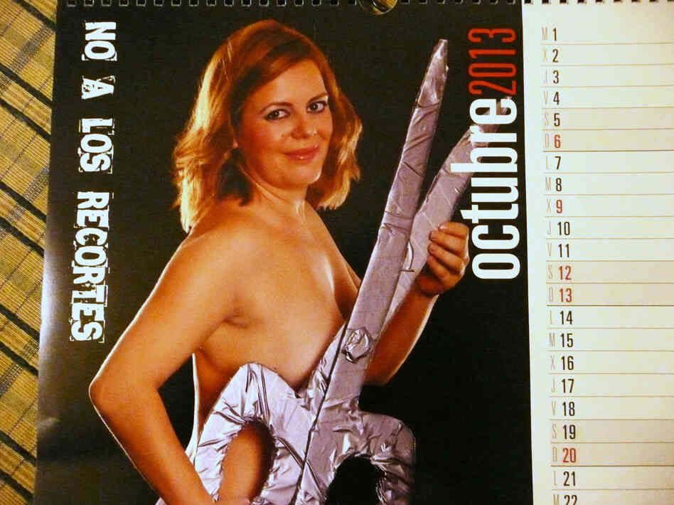 "Ms. October" is one of several moms who posed for a calendar to raise funds for school bus service in their Spanish town. The page reads, "No to the budget cuts!"